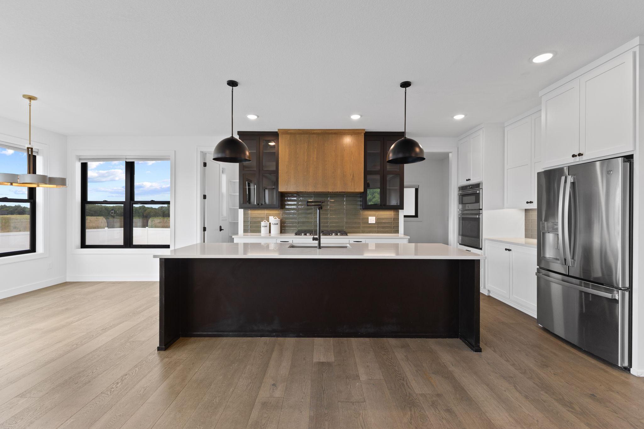 The gourmet kitchen makes a statement with an oversized center island, custom cabinetry and high-end finishes.