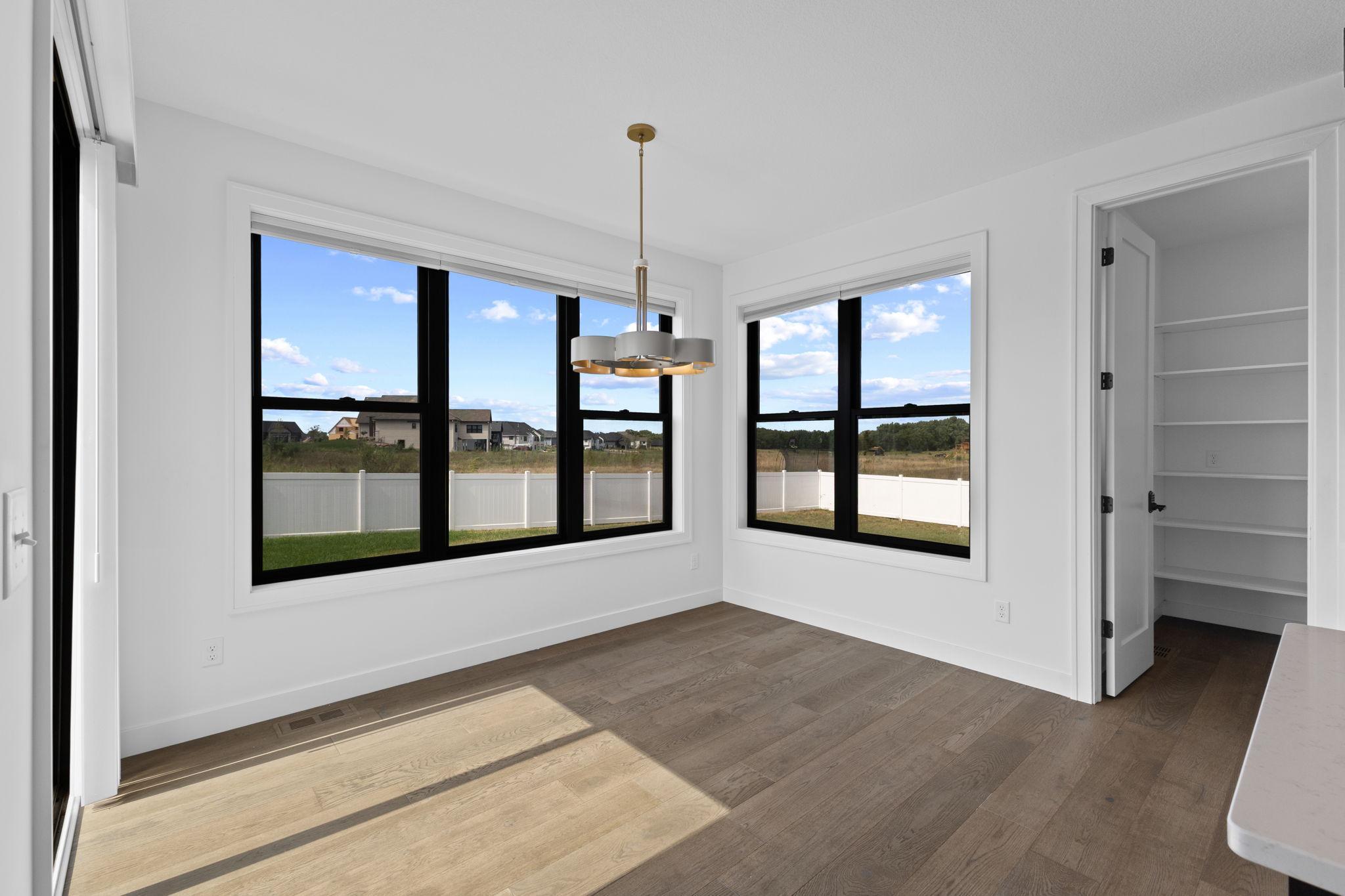 Oversized windows surround the dining area, creating a bright place to gather for meals.