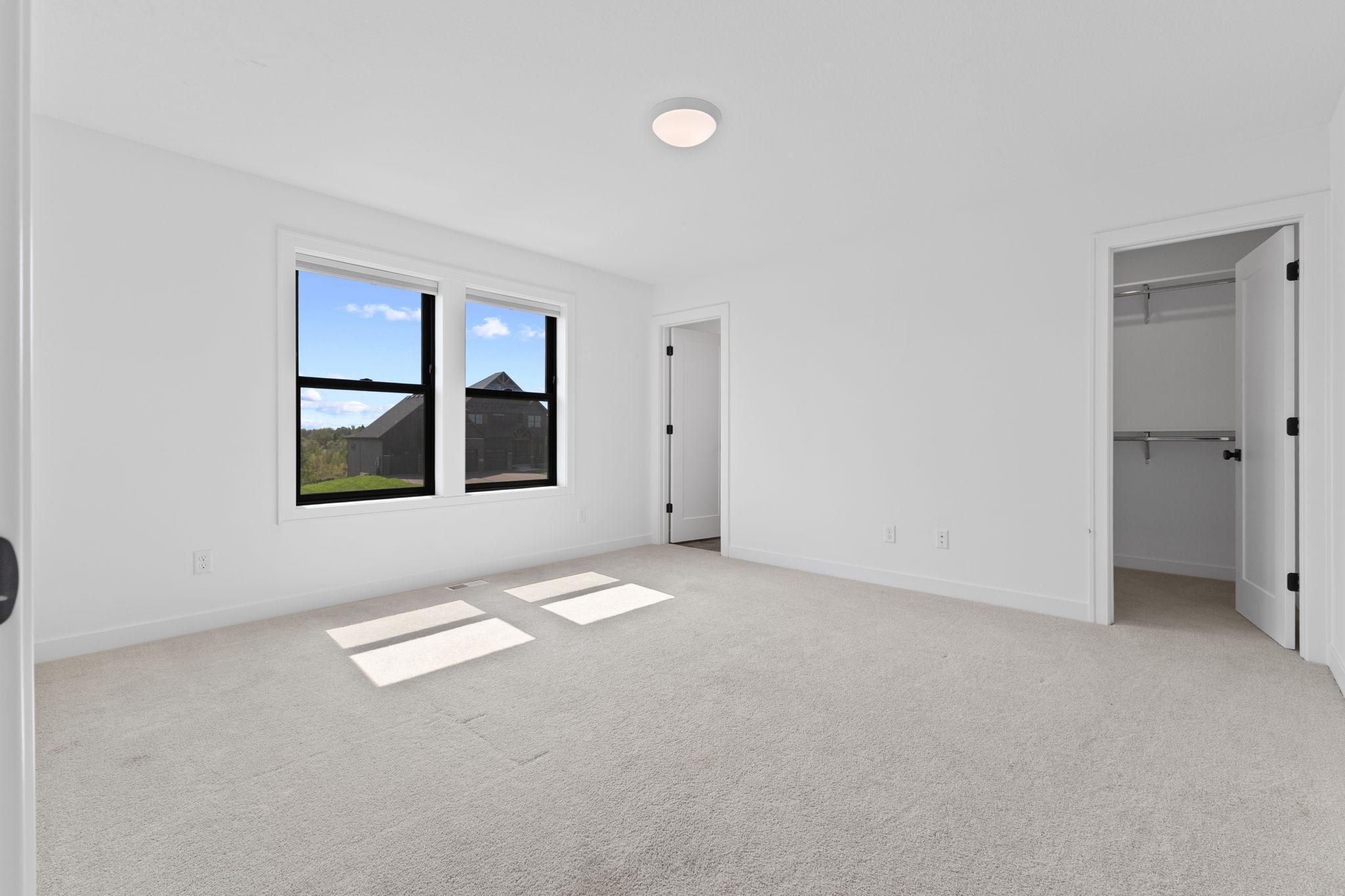 The fourth upper-level bedroom enjoys the added privacy of its own ensuite bath.