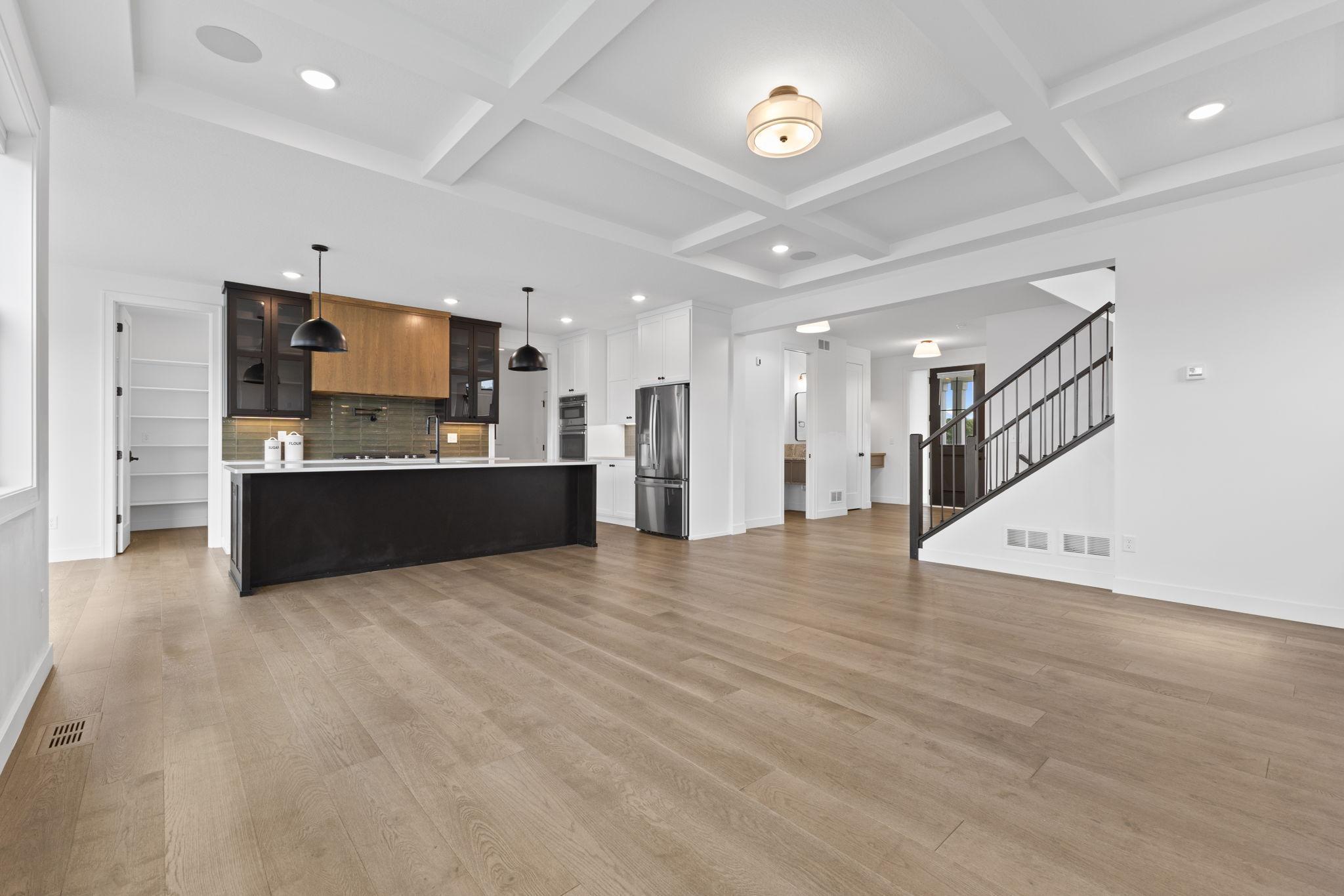 Beautiful wood flooring carries throughout the open main level, creating a seamless flow between spaces.