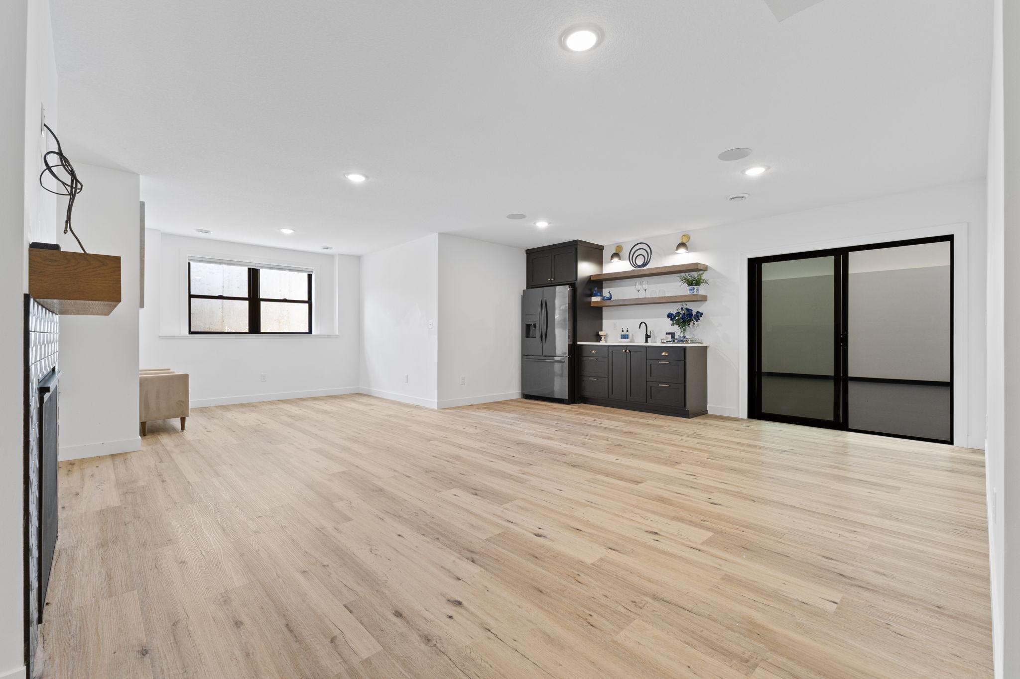 The expansive lower-level family room offers plenty of room for entertaining, games and relaxing.