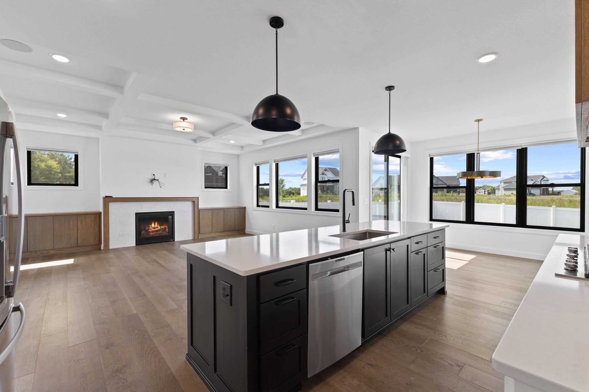Another view showcasing the spacious island and open flow into the surrounding main-level spaces.