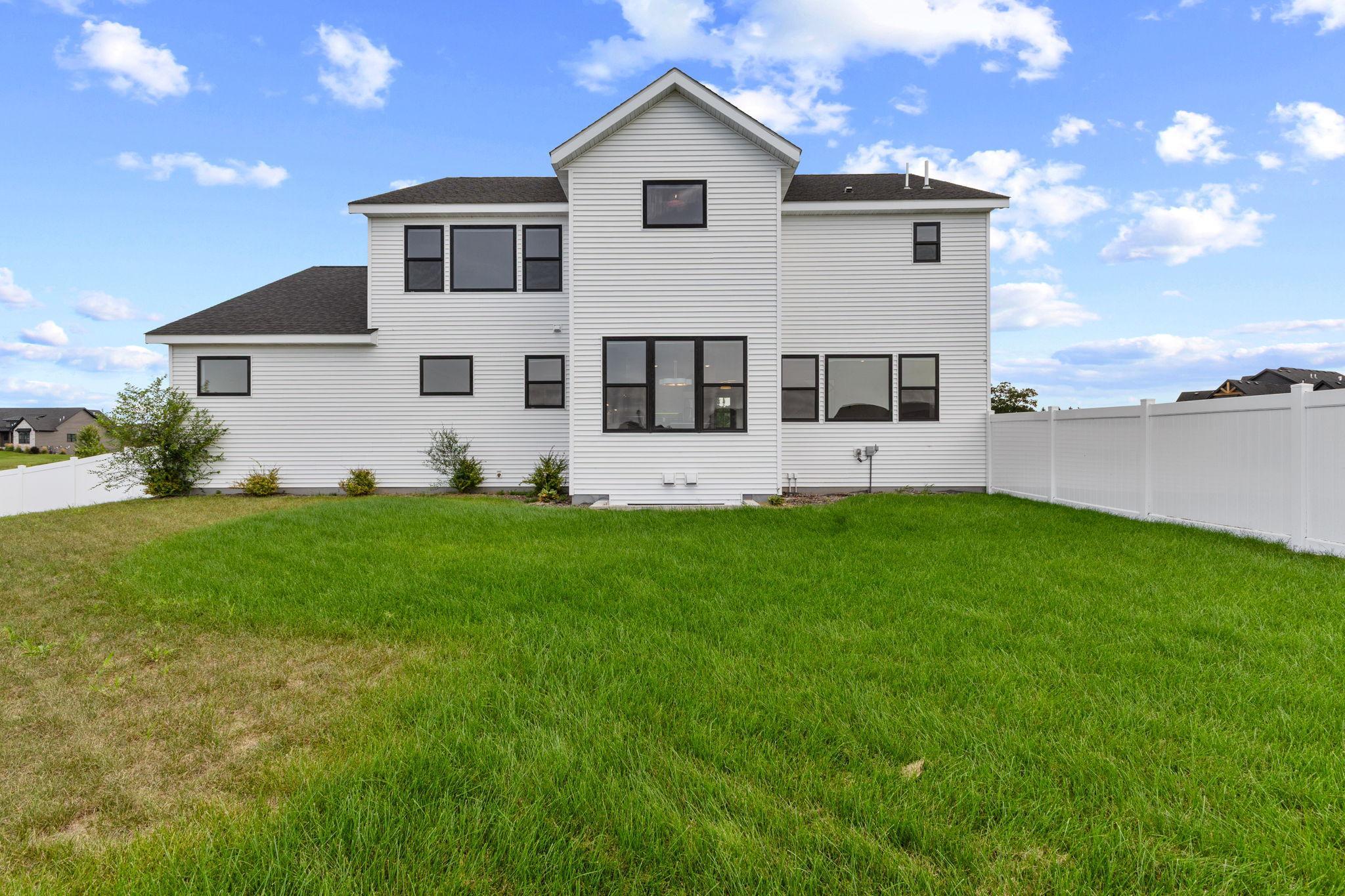 The rear exterior showcases the home's spacious yard.