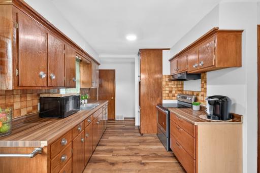 This generous sized kitchen offers much cabinet space...