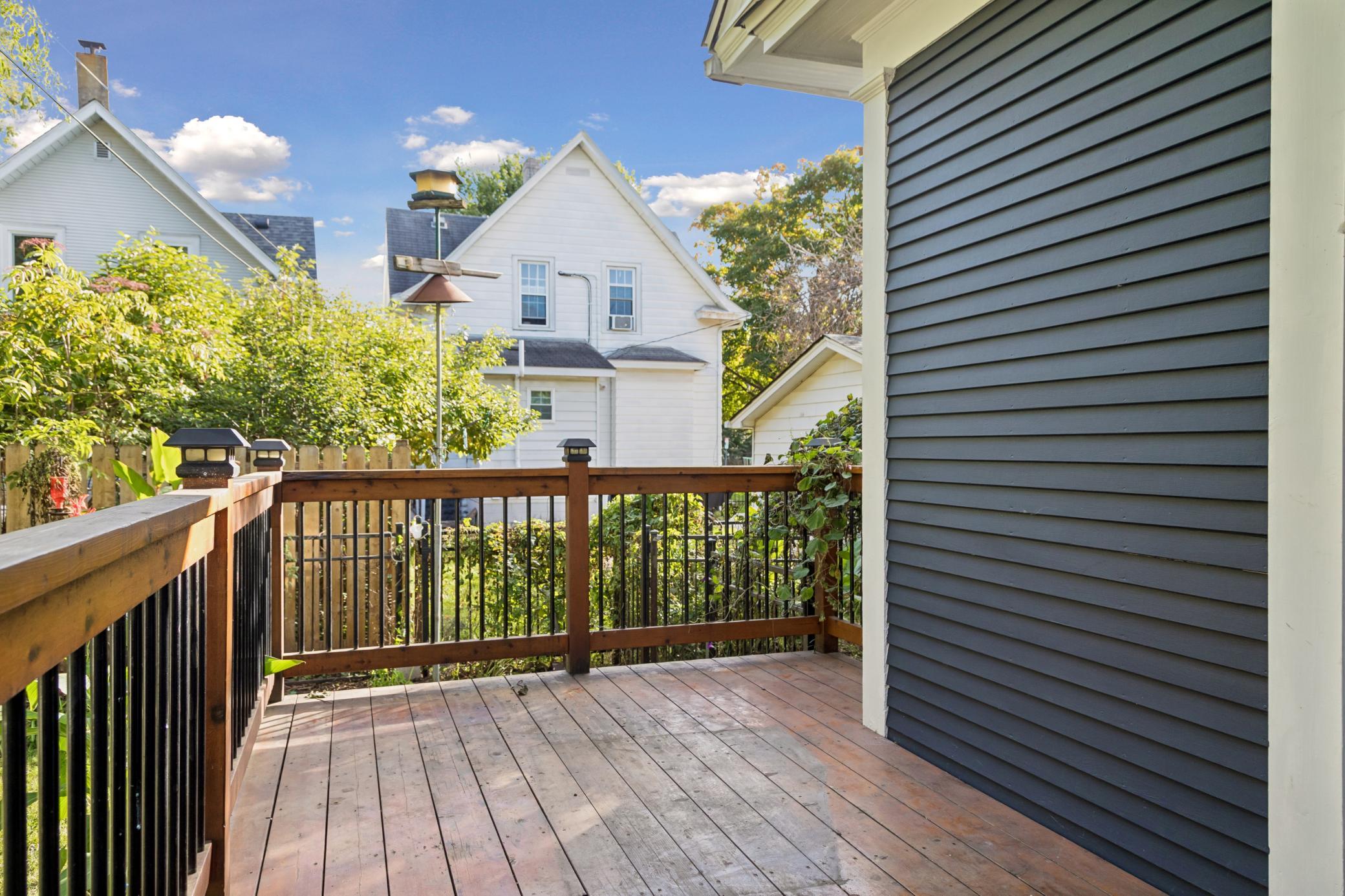 Deck overlooking the fenced backyard.