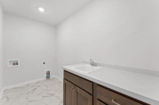 An upper level laundry is a must have, this home offers this large laundry room centrally located to all the upper level bedrooms.