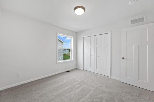 Different angle of the bedroom, showcasing the window.