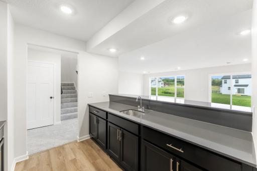 Different view of the wet bar looking out to the recreation room.