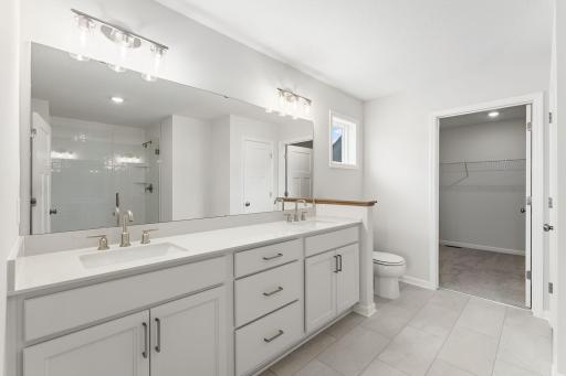 For representational purposes only. The owner's bath has everything you are looking for with a spacious closet, large two sink vanity, walk in shower and ample storage space. (model photo)