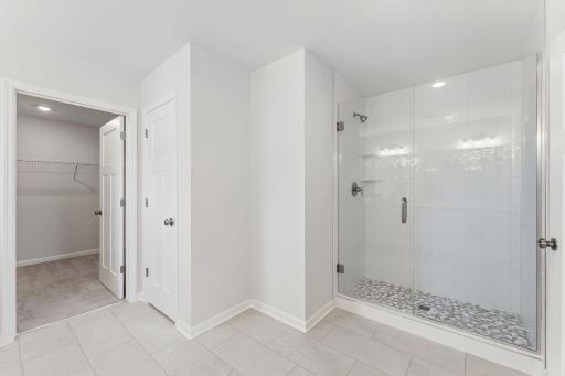 For representational purposes only. Another view of the owner's bath as it opens to the owners walk in closet space. (model photo)