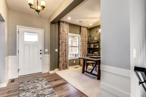 A bright and welcoming foyer featuring luxury vinyl plank flooring provide clean sightlines that immediately showcase the home's open and functional layout. (model photo)