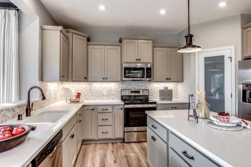 This home has stunning designer selected finishes seen in every detail of the home, including those selection in the beautiful kitchen. (model photo)