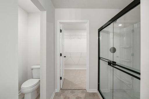 The owner's suite bathroom seamlessly leads into the generous walk-in closet for added convenience.