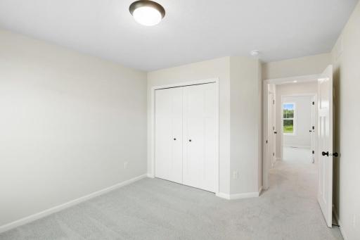 A versatile bedroom with spacious closet and natural light.