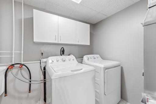 Lower level laundry with storage and a utility sink.