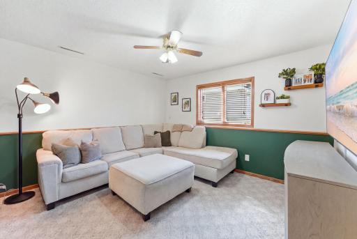 A comfortable lower-level living area provides additional space to relax and gather.