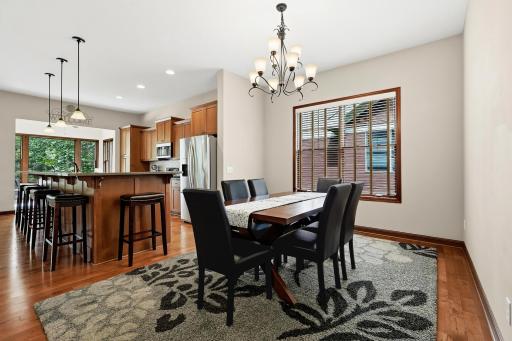 Open & spacious kitchen & dining areas offers polished hardwood floors. The recessed lighting creates a cozy ambiance. Large windows and natural light enhance the inviting atmosphere.