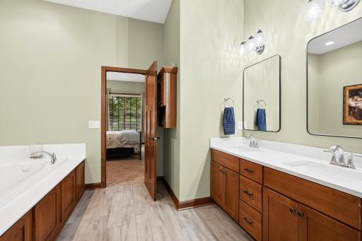 Primary bath offers double bowl vanity, soaking tub and seperate shower.jpg