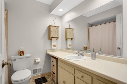 2nd Main-level full bathroom with generous vanity space and tub/shower combination.