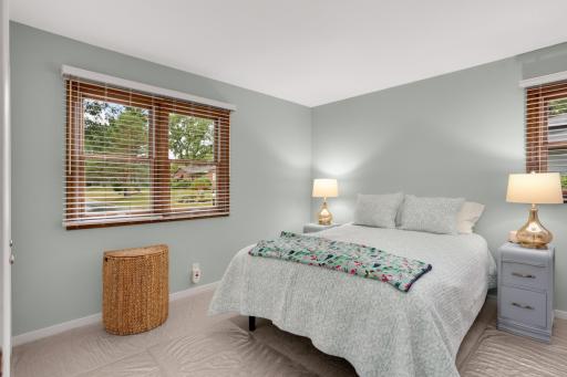 Main-level bedroom with two windows bringing in plenty of natural light.