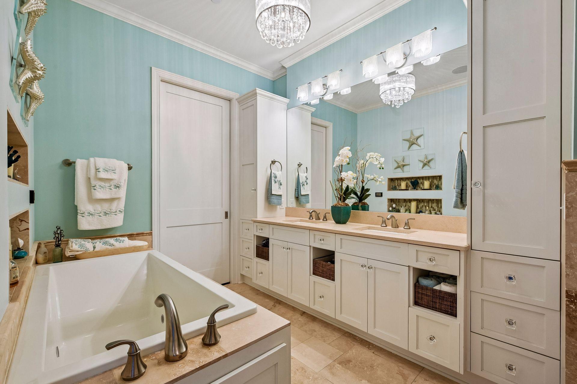 Main floor primary bathroom with walk-in closet and separate tub and walk-in shower