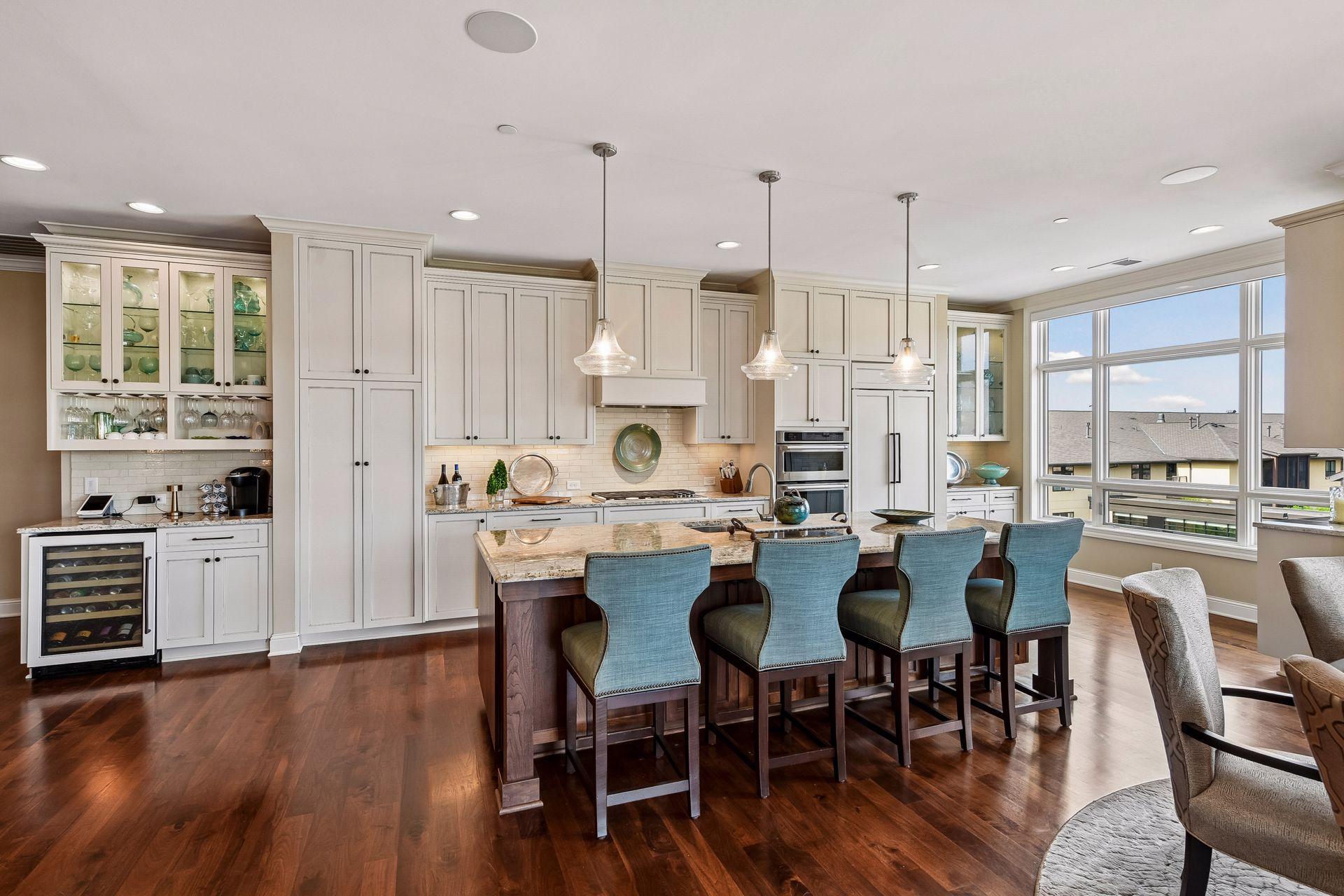 Beautiful open kitchen with spacious center island, stainless steel appliances, and tons of natural light.