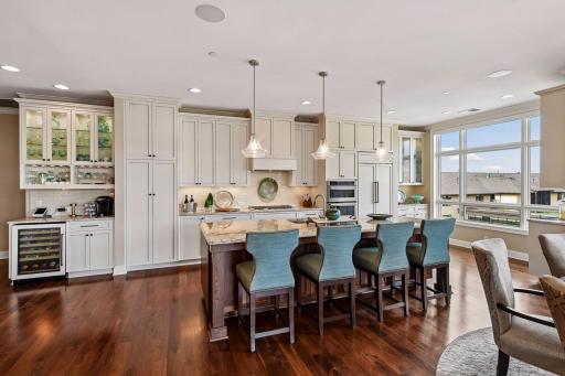 Beautiful open kitchen with spacious center island, stainless steel appliances, and tons of natural light.