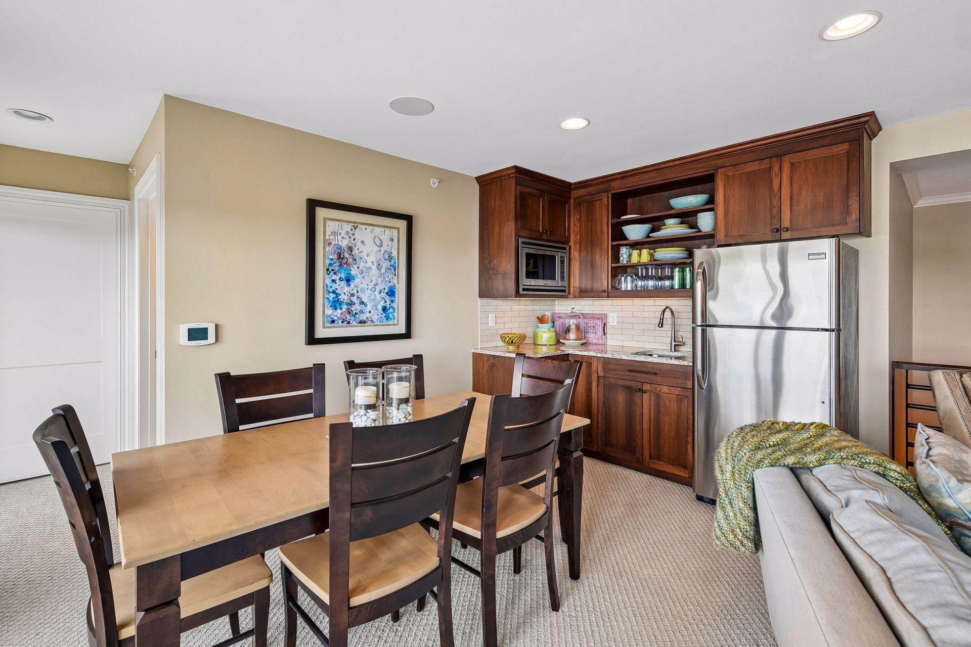 Mini kitchen in the upper level with refrigerator, sink, and lots of storage