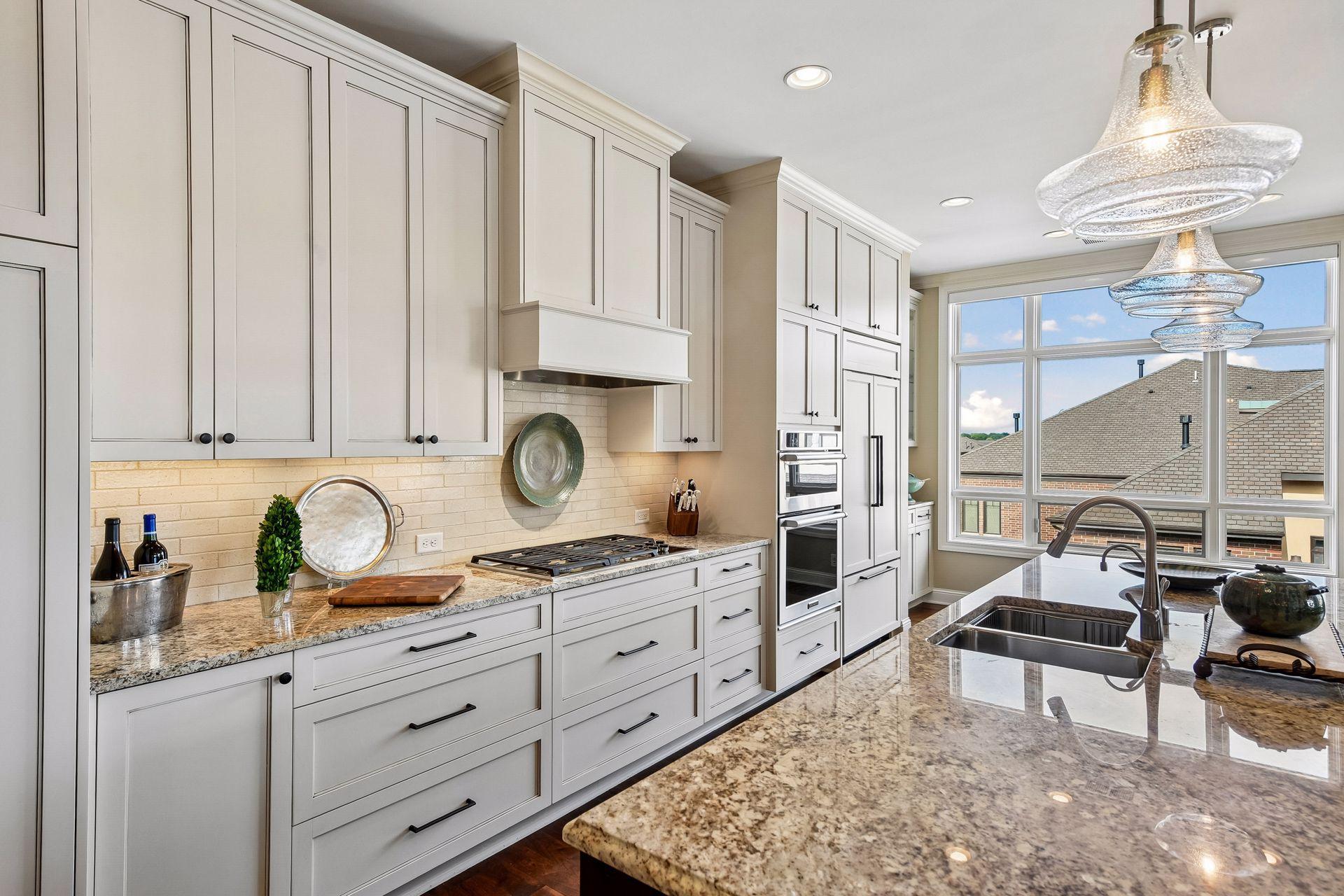 Beautiful open kitchen with spacious center island, stainless steel appliances, and tons of natural light.