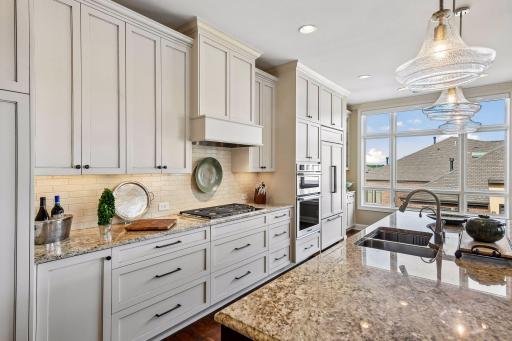 Beautiful open kitchen with spacious center island, stainless steel appliances, and tons of natural light.