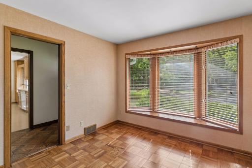 Bright and versatile home office, den or study featuring timeless parquet flooring and a sun-filled bay window. An ideal space for working from home, reading, or hobbies, with classic character and abundant natural light.