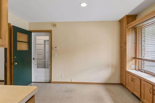 The eat-in dining area is ideal for everyday meals. A nearby doorway provides convenient access to the attached one-car garage and the wonderful, screened porch, privately tucked away at the rear of the home.