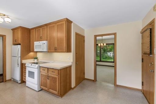 From the screened porch, you'll re-enter the home through the eat-in dining area, where the thoughtful layout provides seamless access to the kitchen, formal dining room and lower level