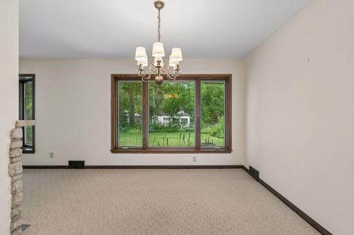 Large picture windows frame beautiful backyard views, filling the living and dining spaces with natural light and a strong connection to the outdoors.