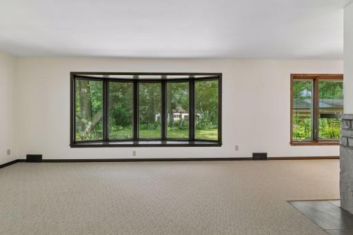 Continue to enjoy peaceful views of the beautifully landscaped backyard through the living room's large picture windows, bringing the outdoors in year-round.