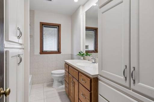 Ideally positioned between the two main-level bedrooms, the updated full bath offers a spacious vanity, excellent storage, and a tiled tub surround for lasting appeal.