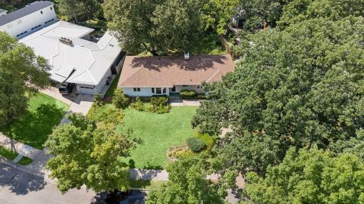 Situated on a beautifully landscaped quarter-acre lot, this home offers an exceptional location just one block from Cedar Lake.