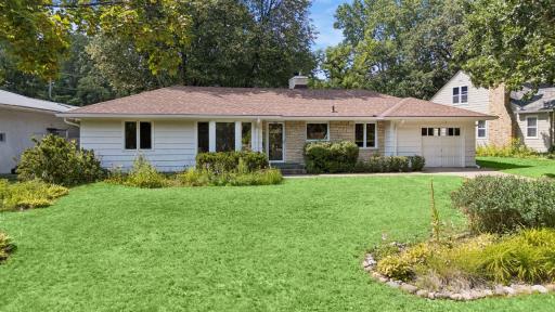Established perennial garden beds frame the home, while an in-ground sprinkler system helps keep the landscape looking its best.