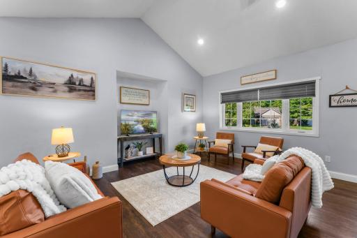 Vaulted ceilings and picture windows that pull in the front yard view within the living room.
