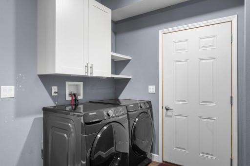 Conveniently located laundry room with direct access to the attached two-car garage, while also offering the functionality of a mudroom.
