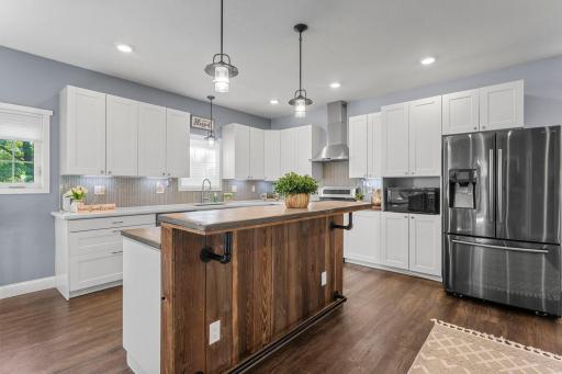 Featuring an oversized center island where everyone naturally gathers, and a tile backsplash that catches the eye.