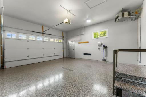 Finished, insulated, and heated two-car garage featuring durable epoxy flooring added in 2023 - perfect for year-round use and extra workspace.