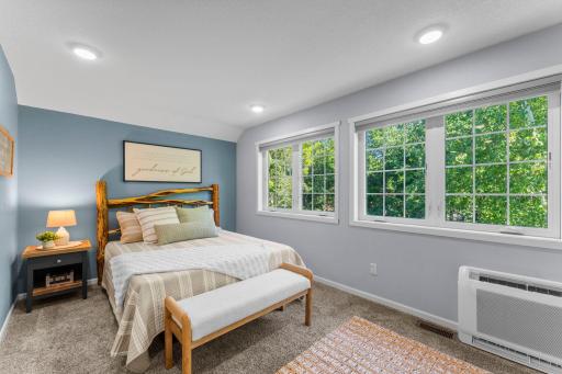 Primary suite overlooking the wooded side yard.