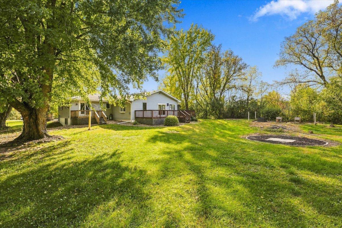 Large private backyard with big, mature trees, open green space and a fire pit area for bonfires.