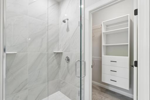 Primary Shower with floor to ceiling Tile