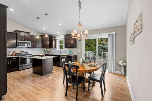 Large and welcoming kitchen walks out to the multi-layered deck. 1515 138th St E, Rosemount, MN