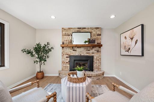 The gas fireplace with timeless brick surround is on a thermostat remote!