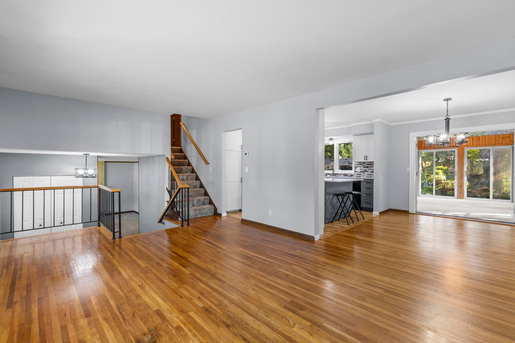 Open-concept living connects the living room, kitchen, dining area, and four-season porch for an easy, spacious flow.