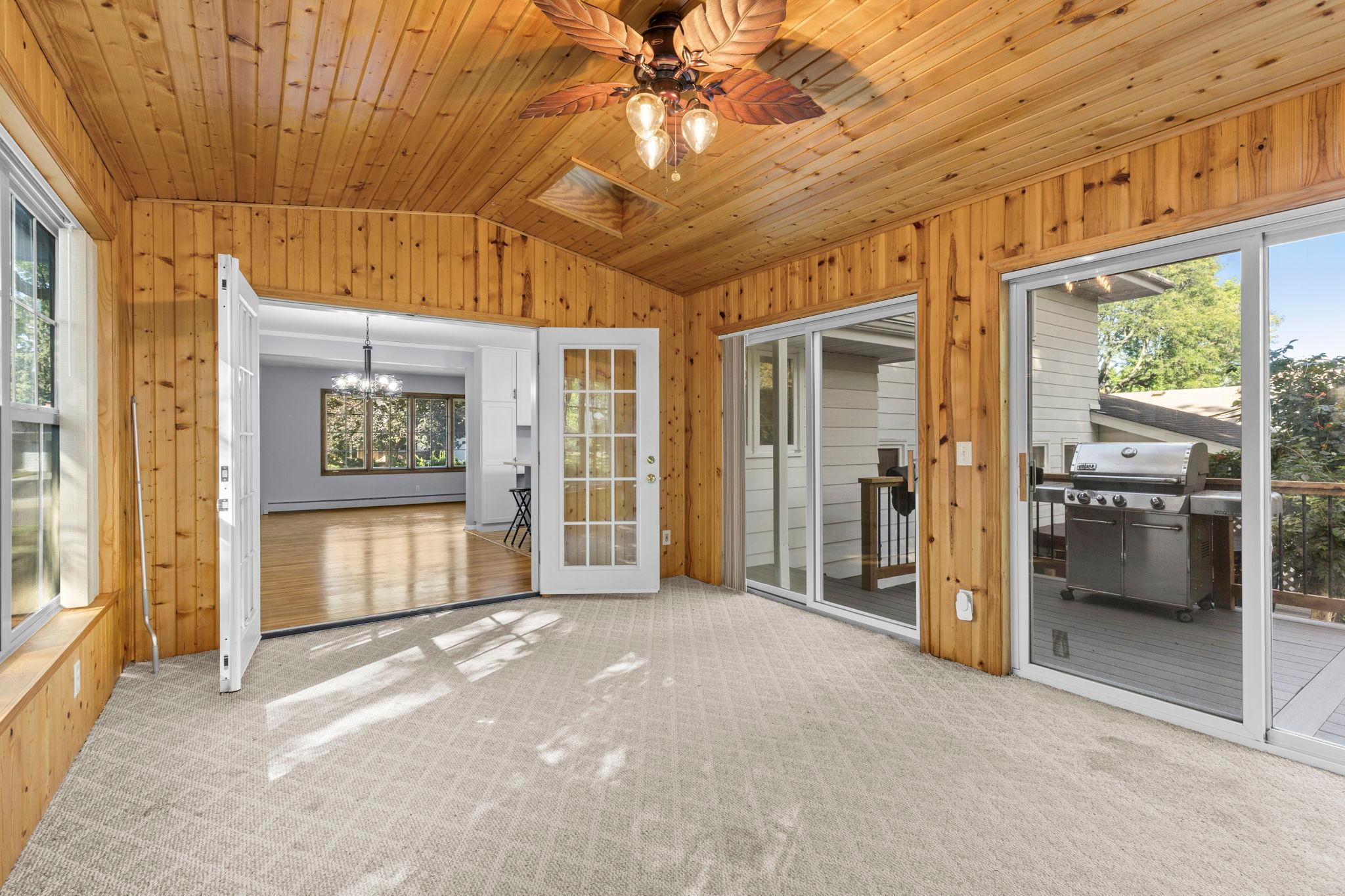French doors leading into 4-season porch from dining room