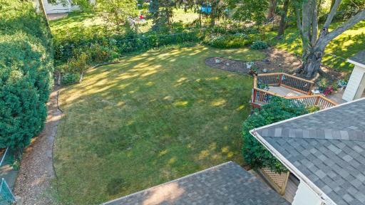 Generous backyard with a level lawn and thoughtful landscaping that adds beauty and privacy